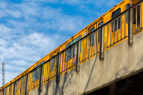Photography BERLIN, GERMANY - Jan 12, 2020: Yellow U-Bahn train crossing a bridge at Böcklerpark (close to Prinzenstraße subway station)
