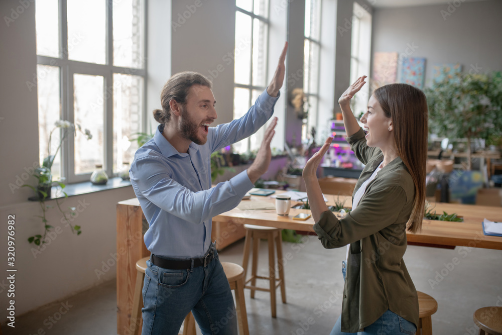 Joyful man and woman clapping their hands Joyful man and woman clapping their hands