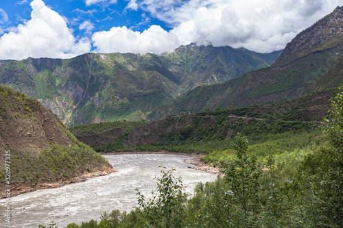 Panorama view of Yarlung Tsangpo (Yarlung Zangbo) Grand Canyon , Brahmaputra Canyon or Tsangpo Gorge and Yarlung Tsangpo River in summer wit blue sky cloud, Tibet, China