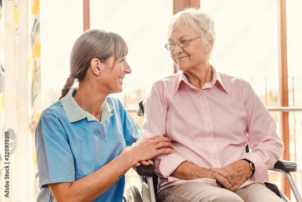 Obraz premium Caregiver with senior woman in pension home