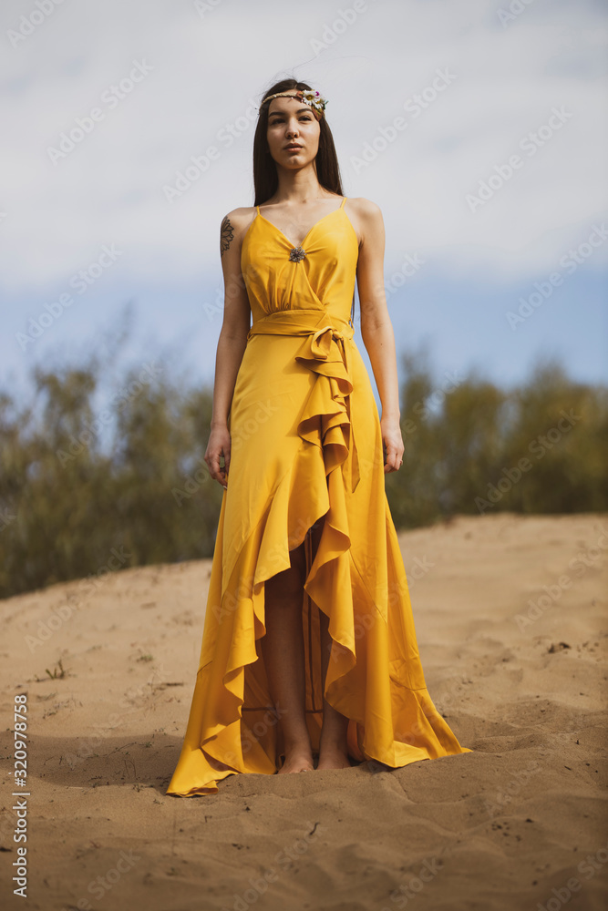 Attractive girl in the yellow dress