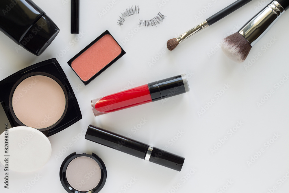 Make up items in black cases on light grey color background. Top view set of decorative cosmetic with space for text. Minimal style. Make up items in black cases on light grey color background. Top view set of decorative cosmetic with space for text. Minimal style.