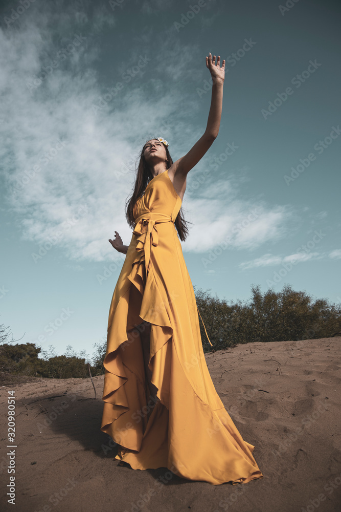 Fototapeta premium Attractive girl in the yellow dress