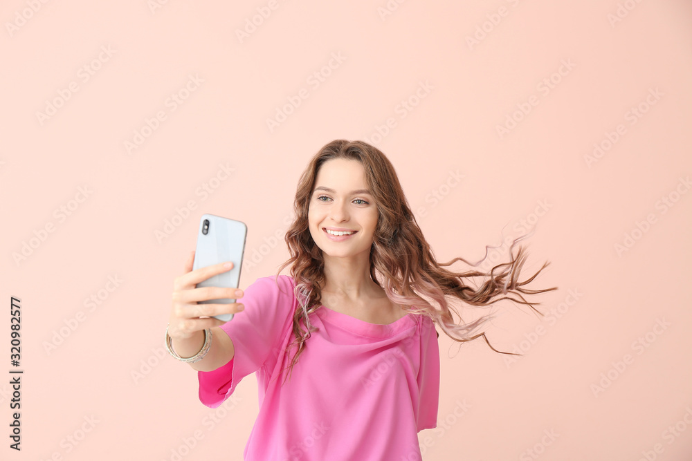 Young woman taking selfie on color background Young woman taking selfie on color background