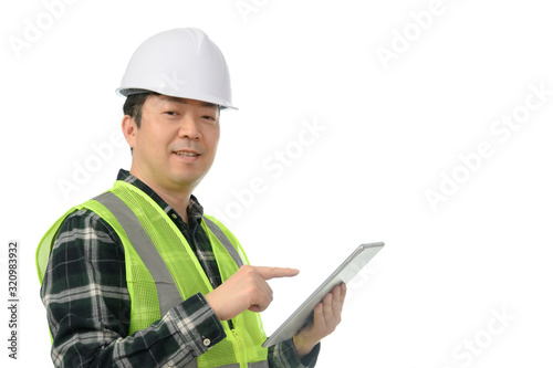 Middle-aged Asian engineer using tablet PC on a white background.
