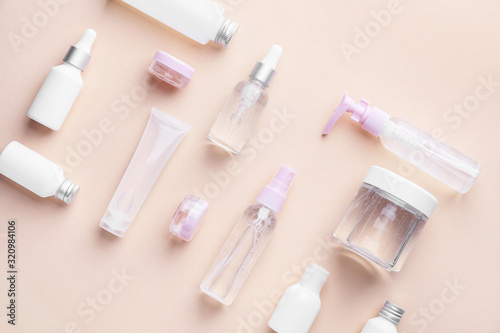Different cosmetic products on color background