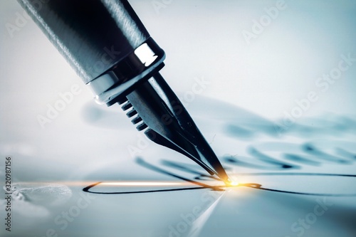 Signing a signature with a classic fountain pen photo