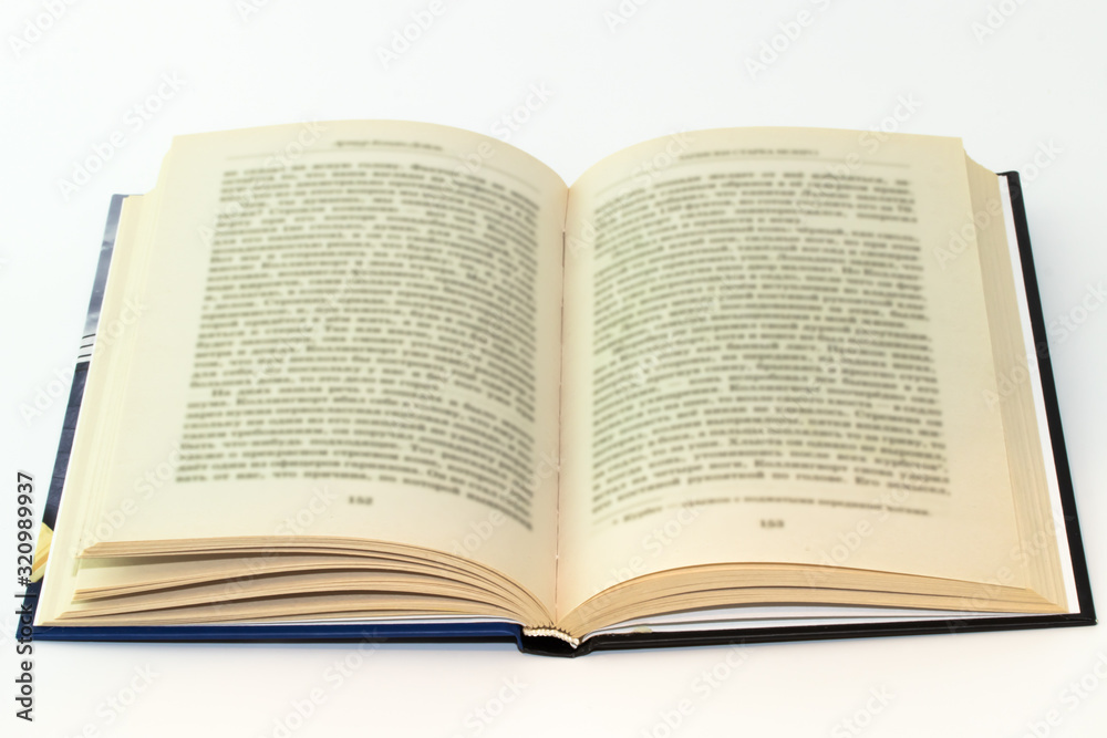 Open book with blurred text on white background Open book with blurred text on white background