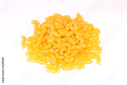 A pile of pasta horns on white background