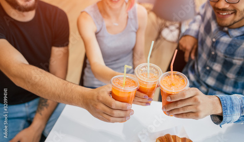 Healthy people toasting with carrot juice