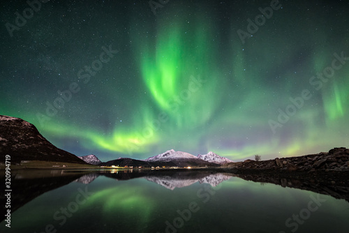 Northern lights with mountain reflection