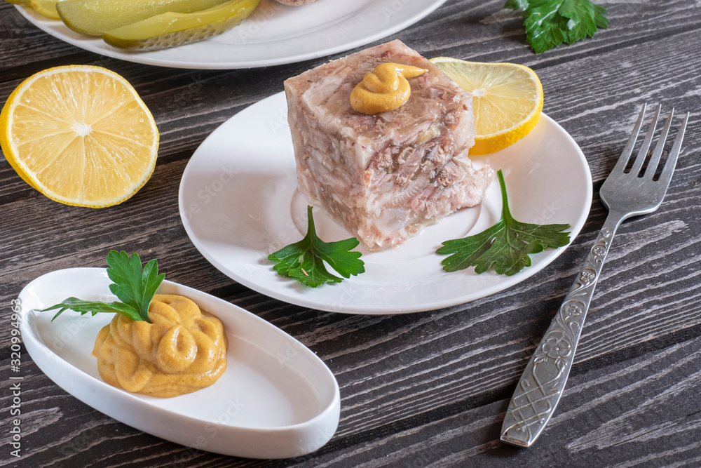 aspic with mustard, bread, pickled cucumbers and parsley on a dark wooden background aspic with mustard, bread, pickled cucumbers and parsley on a dark wooden background