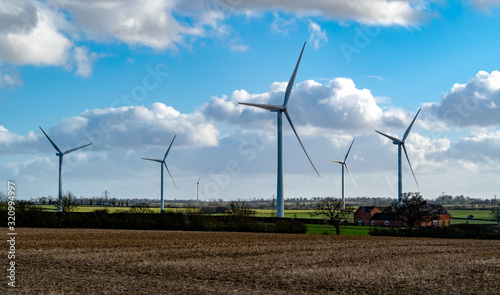 Wind farm park near Yelvertoft on bright cloudy day photo