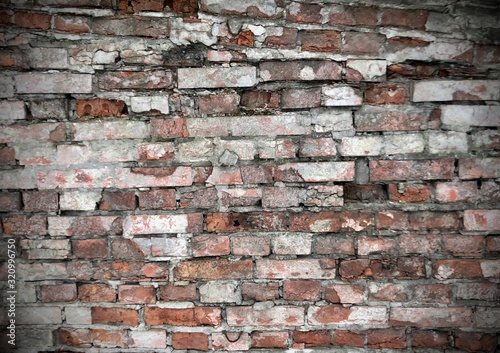 a wall of bricks of white  orange  gray colors. Background  texture  bumps  naturalness  vintage