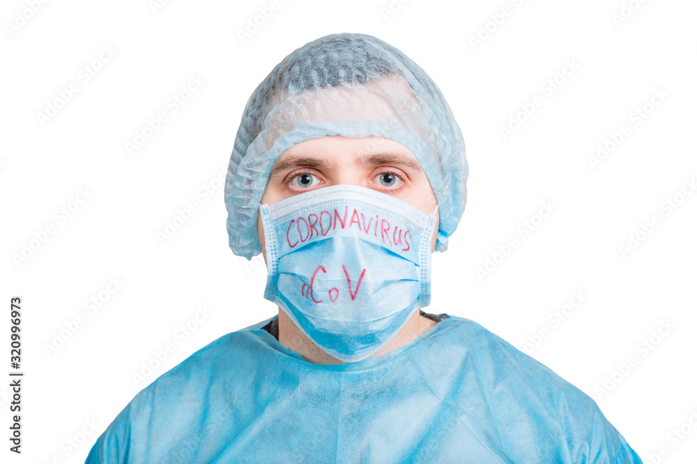 Portrait of ill man in medical unifrom and protective mask with coronavirus nCoV text isolated on white background. Respiratory protection. Coronavirus concept Portrait of ill man in medical unifrom and protective mask with coronavirus nCoV text isolated on white background. Respiratory protection. Coronavirus concept