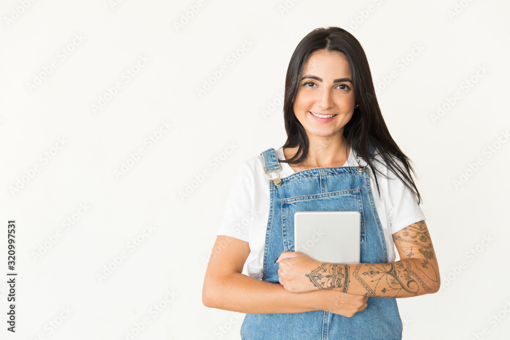 Content young woman holding tablet pc. Cheerful young woman holding digital tablet and smiling at camera isolated on white background. Wireless technology concept Content young woman holding tablet pc. Cheerful young woman holding digital tablet and smiling at camera isolated on white background. Wireless technology concept