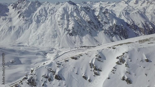 Breathtaking winter panorama in the switzerland alps, in the background are few skier. photo