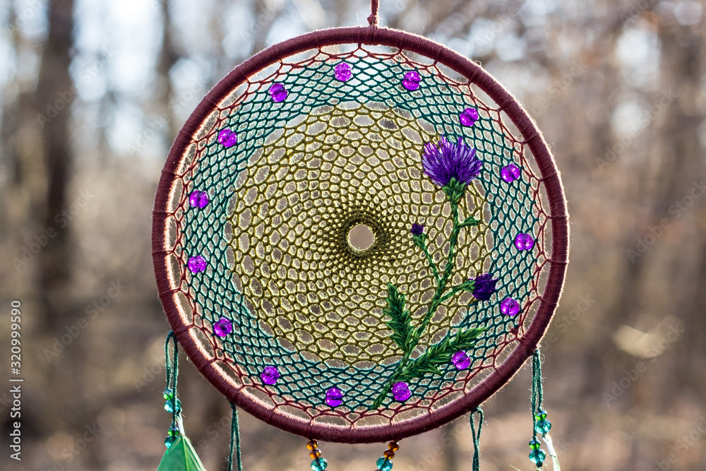 Naklejka premium Handmade dream catcher with feathers threads and beads rope hanging