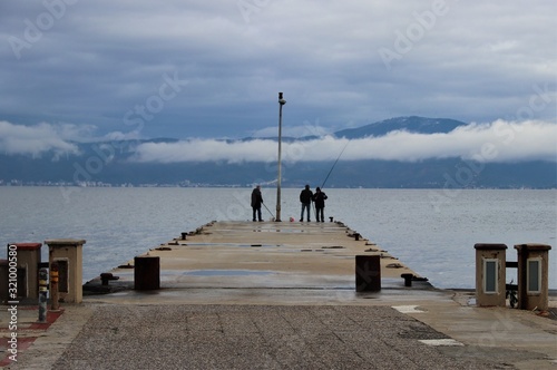 fishermen on the pier, trilye, mudanya  photo