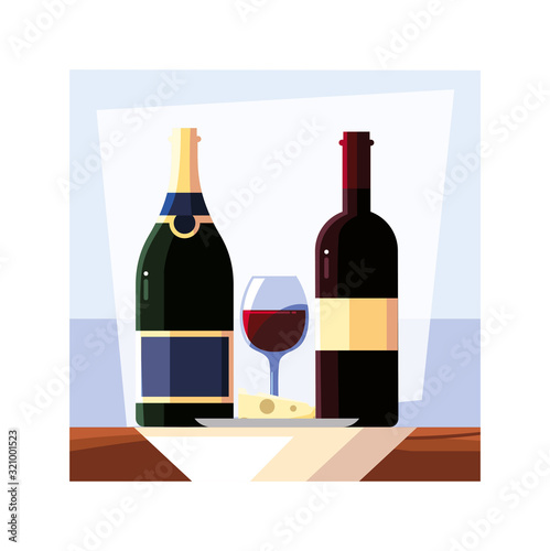 bottle and glass of wine with piece of cheese