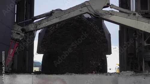 The mining dump truck unloads ore into the crushing complex. photo