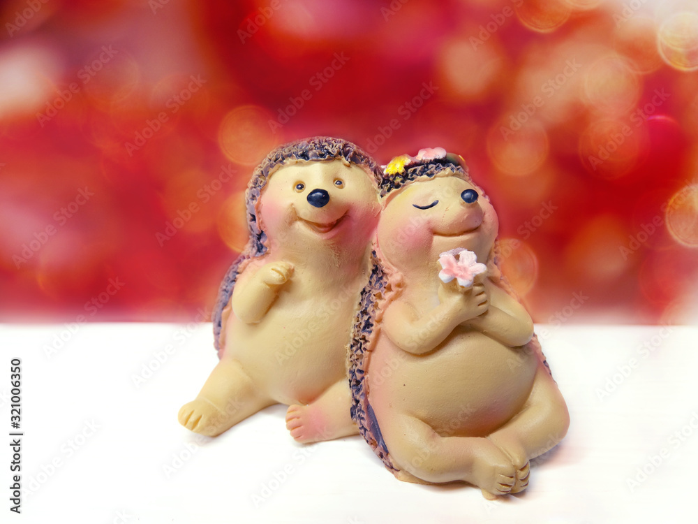valentine's day card with hedgehogs couple toys on bokeh background