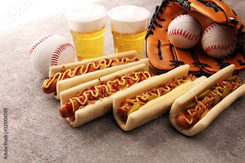 Photography Grilled hot dogs with mustard and ketchup on the table with draft beer