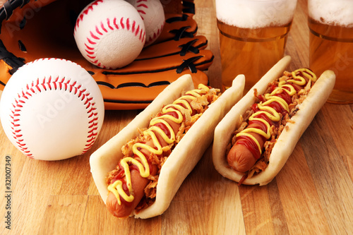 Photography Grilled hot dogs with mustard and ketchup on the table with draft beer