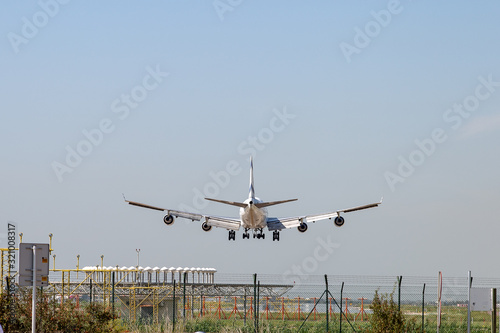 Airplane landing on runway back view. Concept of holidays