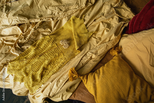  Yellow knitted dress on the bed ,spring collage on a yellow background.Top view flat lay.