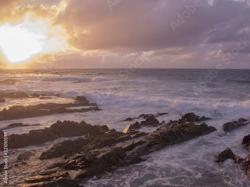 stone coast, water waves and beautiful sunset