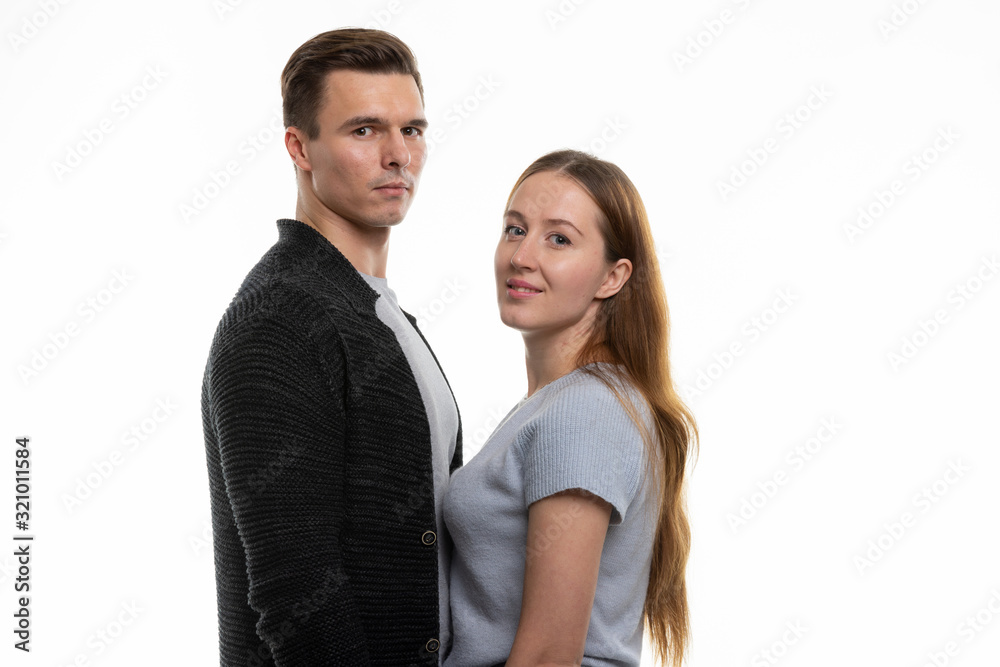 Portrait of a young family, standing opposite each other and looked into the frame