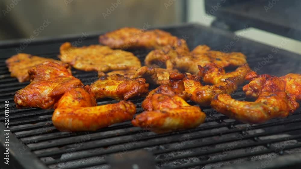 Closeup of Cooking Juicy Steaming Chicken and Beef Meat on a Charcoal Grill. Picnic in Summer Outdoors. Leisure, Food and Holidays Concept Closeup of Cooking Juicy Steaming Chicken and Beef Meat on a Charcoal Grill. Picnic in Summer Outdoors. Leisure, Food and Holidays Concept