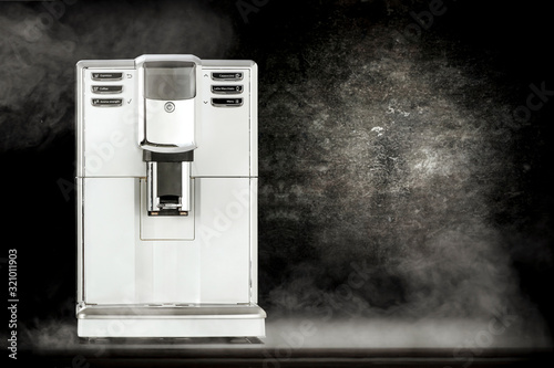 White coffee machine and black background space with smoke 