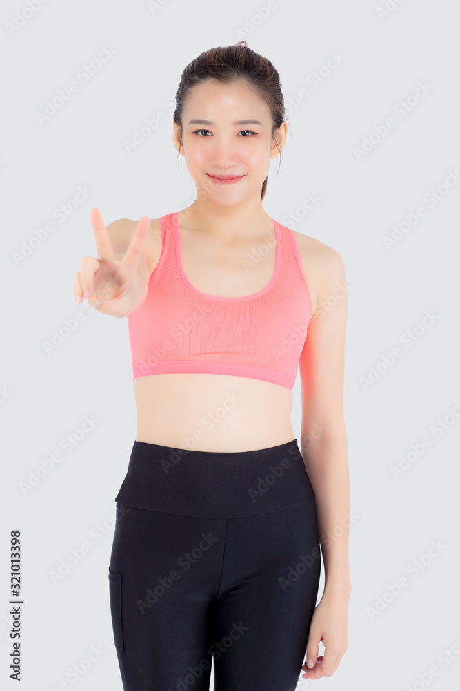 Beautiful portrait young asian woman in sport clothes with satisfied and confident gesture finger v sign isolated on white background, asia girl have shape and wellness, exercise for fit with health. Beautiful portrait young asian woman in sport clothes with satisfied and confident gesture finger v sign isolated on white background, asia girl have shape and wellness, exercise for fit with health.