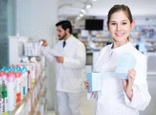 pharmacist who is standing with medicine photo