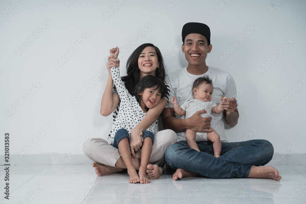 happiness asian family with two daughter sitting on the floor have fun on white background
