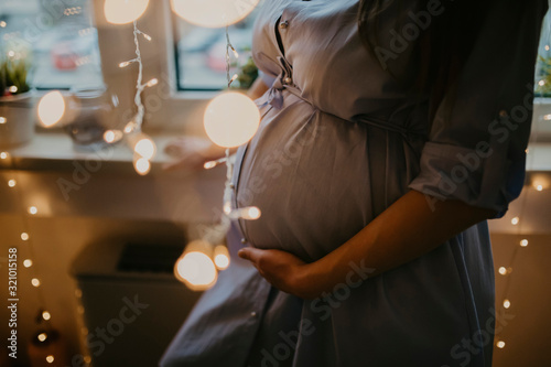 Detail of a pregnant lady holding her belly