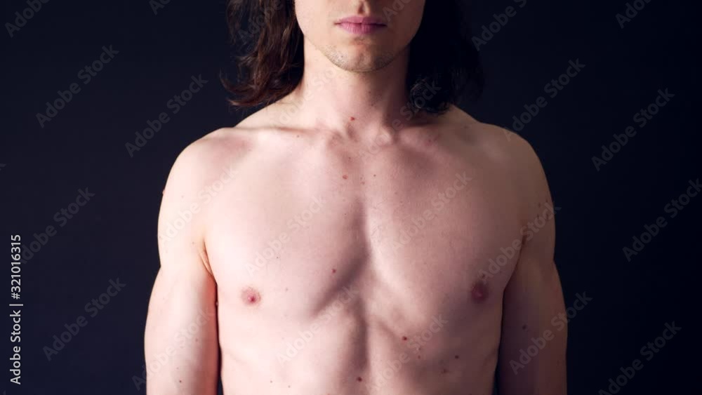 A strong shirtless white man flexing his upper body muscles in the gym after a tough fitness training workout. A strong shirtless white man flexing his upper body muscles in the gym after a tough fitness training workout.