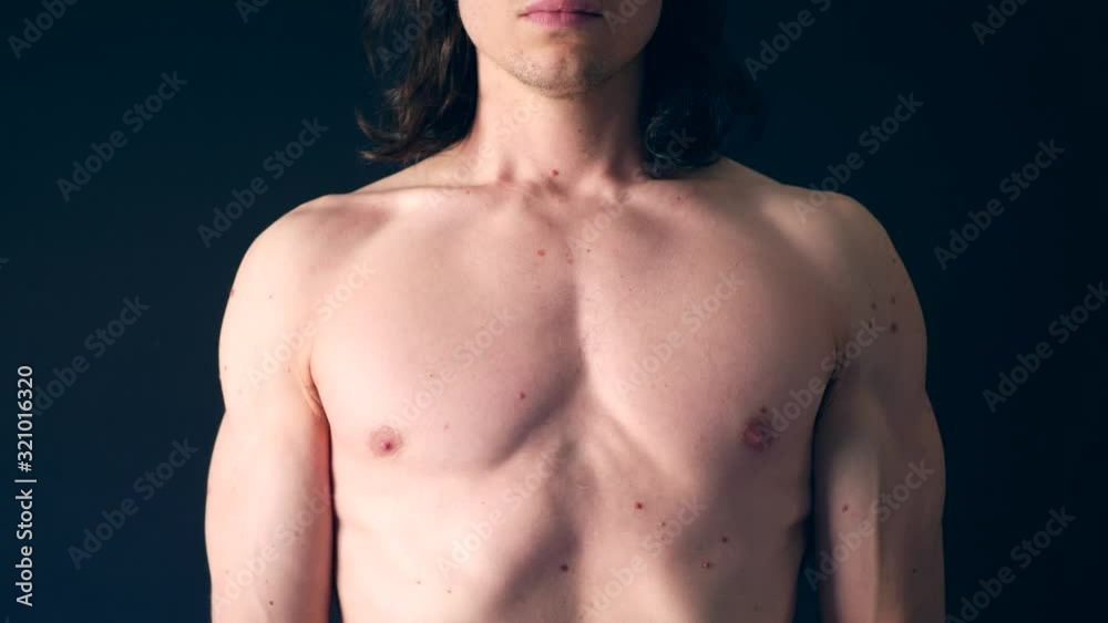 A strong shirtless white man taking a calming deep breath after a body workout to gain strength SLOW MOTION. A strong shirtless white man taking a calming deep breath after a body workout to gain strength SLOW MOTION.
