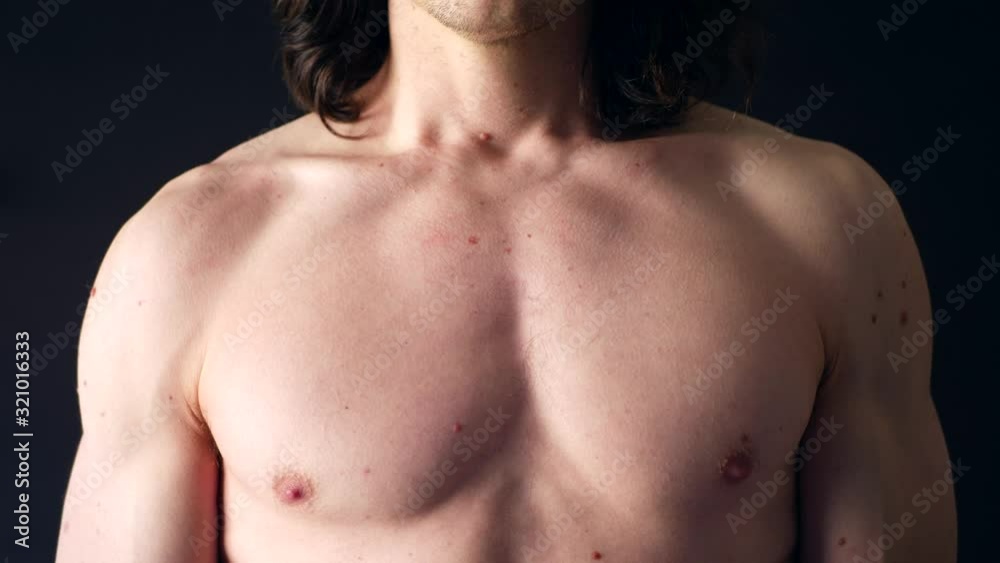 A strong shirtless white man taking a calming deep breath in his chest after a body workout SLOW MOTION. A strong shirtless white man taking a calming deep breath in his chest after a body workout SLOW MOTION.
