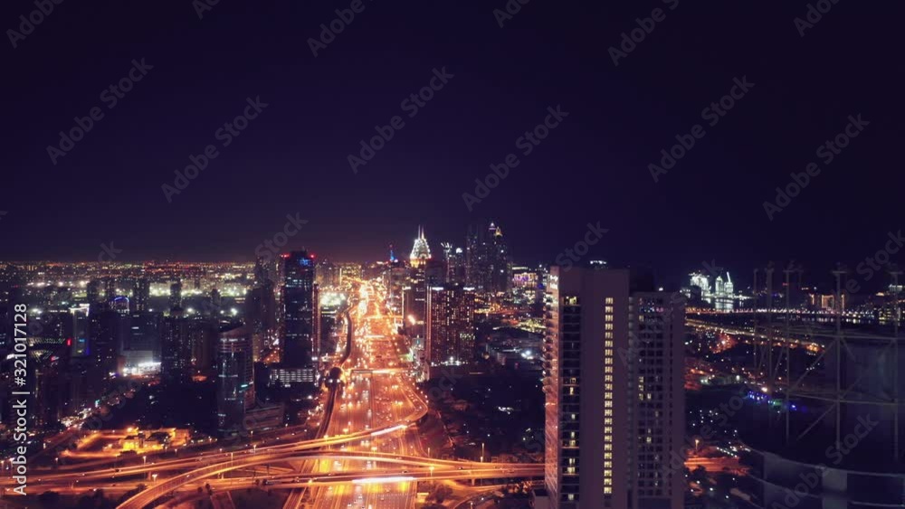 Aerial night illuminated Dubai city skyline skyscrapers view and busy traffic on Sheikh Zayed road highway Aerial night illuminated Dubai city skyline skyscrapers view and busy traffic on Sheikh Zayed road highway