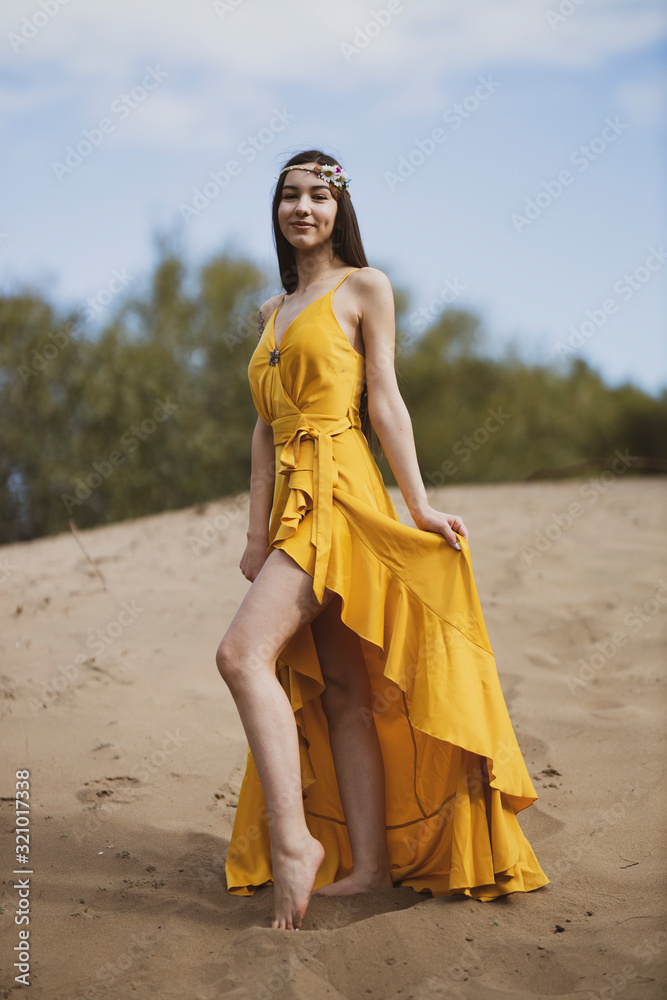 Fototapeta premium Attractive girl in the yellow dress