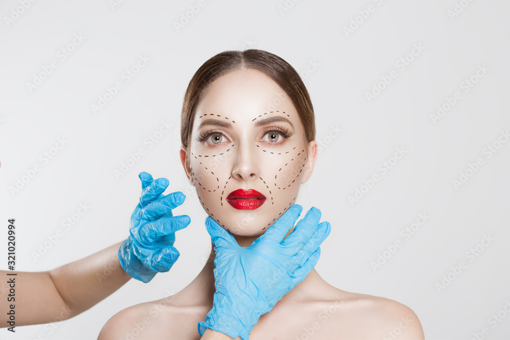 Facial cosmetic plastic surgery. Doctor surgeon hand in glove draw