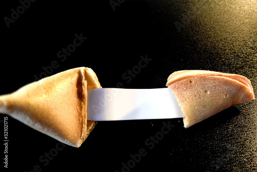 open fortune cookie with a blank note for your message photo