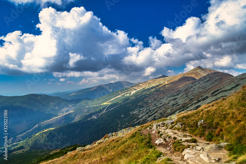 Fototapeta Naklejka Na Ścianę i Meble -  Mountainous landscape with hills and valleys at a sunny day in autumn season. The Low Tatras National Park in Slovakia, Europe.