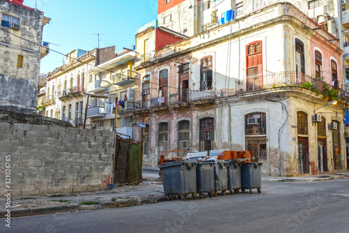 Colorful street in Havana with houses and garbage bins