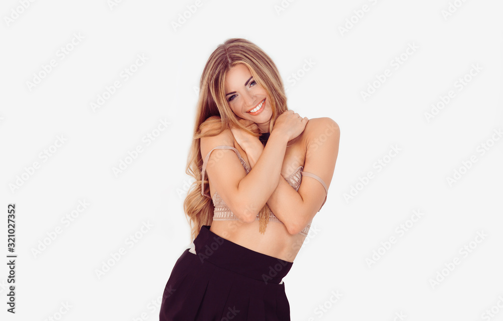 Healthy and happy. Closeup portrait confident smiling woman holding hugging herself her breast isolated white gray wall background. Positive human emotion, facial expression, feeling, reaction Healthy and happy. Closeup portrait confident smiling woman holding hugging herself her breast isolated white gray wall background. Positive human emotion, facial expression, feeling, reaction