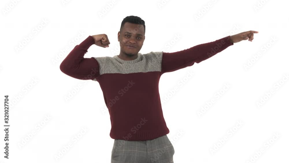 Close-up of a smiling young man demonstrating biceps over white background Close-up of a smiling young man demonstrating biceps over white background
