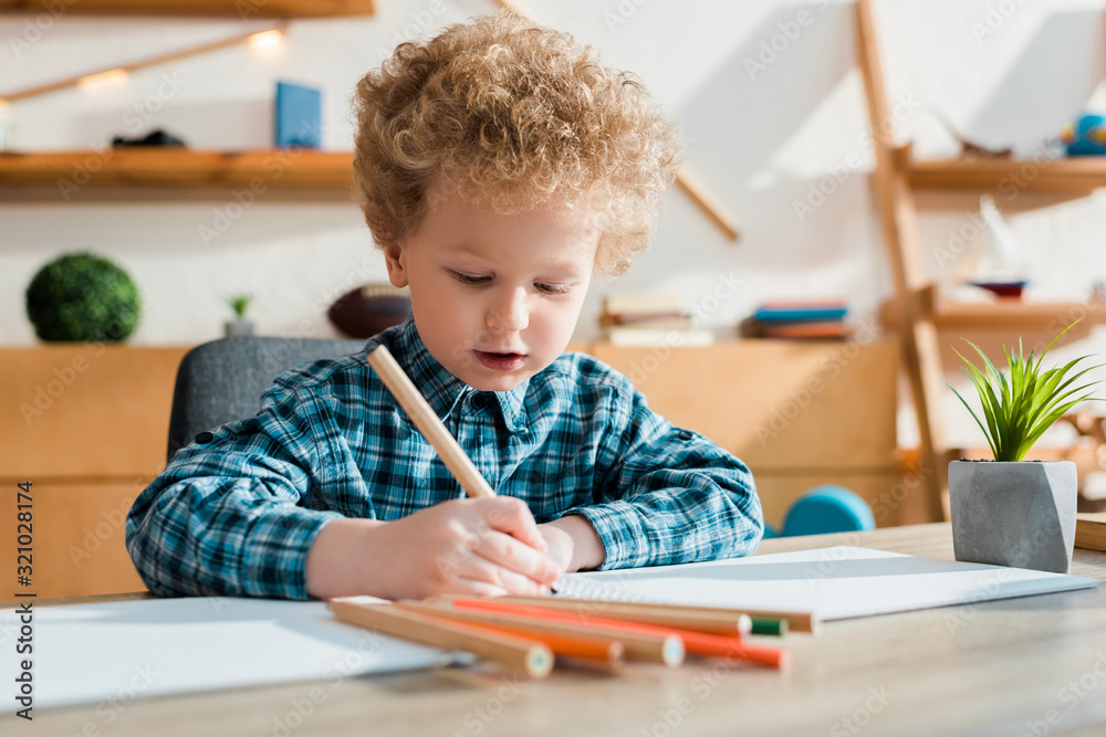 selective focus of kid drawing at desk selective focus of kid drawing at desk